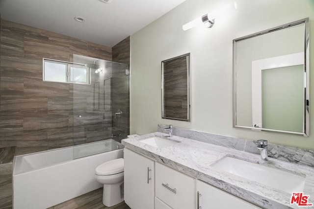 full bathroom with toilet, vanity, and combined bath / shower with glass door