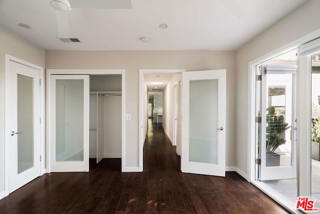 unfurnished bedroom with french doors, a closet, and dark hardwood / wood-style floors