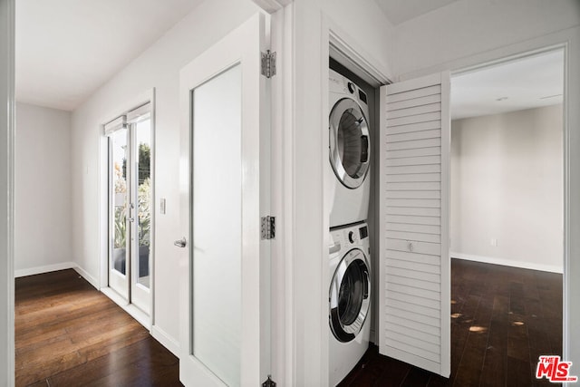 laundry area with stacked washer / drying machine and dark hardwood / wood-style flooring