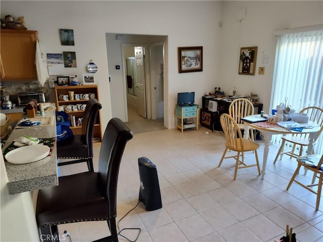 dining area with light tile patterned floors