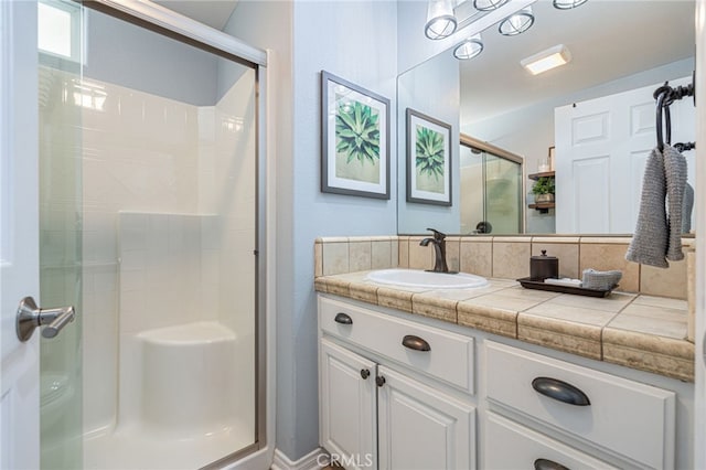 bathroom with an enclosed shower and vanity