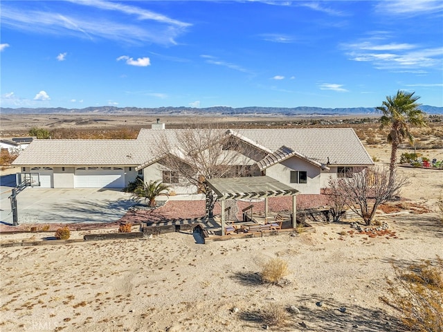 view of front facade with a mountain view and a garage