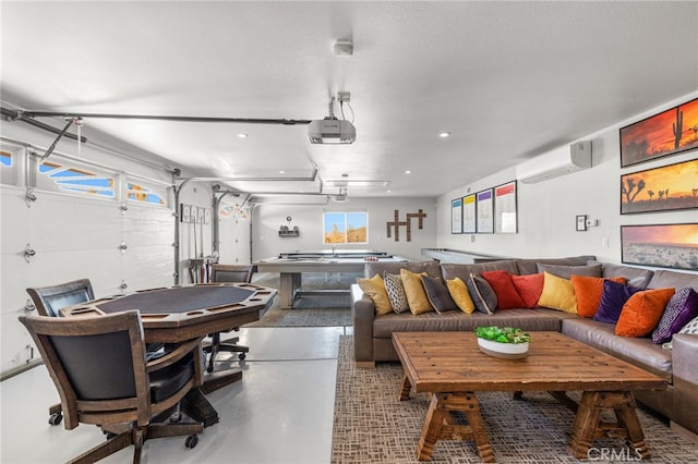 interior space featuring a wall unit AC, concrete floors, and a textured ceiling