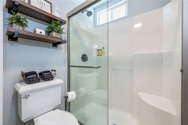 bathroom with toilet and walk in shower