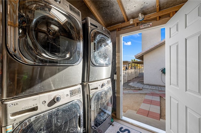 washroom featuring tile patterned floors and stacked washing maching and dryer