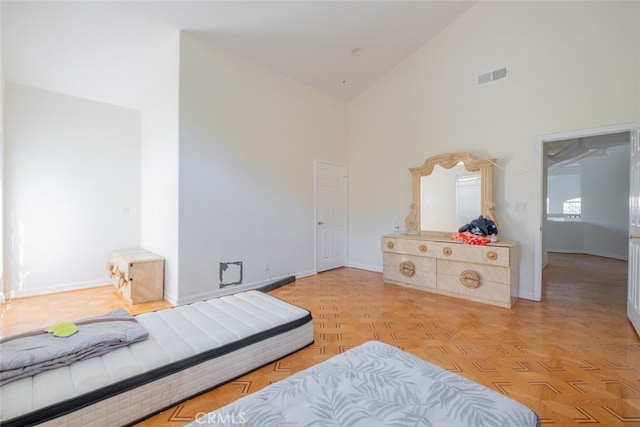 bedroom with high vaulted ceiling