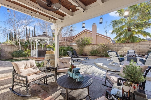 view of patio with an outdoor hangout area, a gazebo, and a fenced backyard