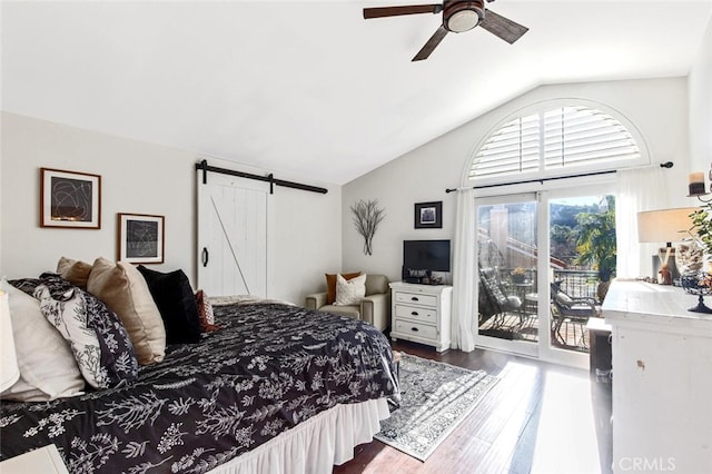 bedroom with access to exterior, dark wood-style flooring, a barn door, vaulted ceiling, and ceiling fan