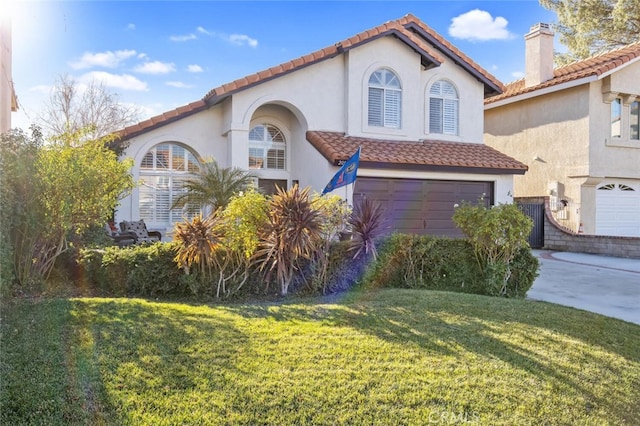 view of front of house with a garage and a front lawn