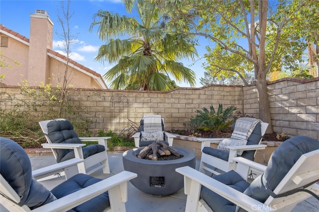 view of patio / terrace featuring a fire pit and a fenced backyard