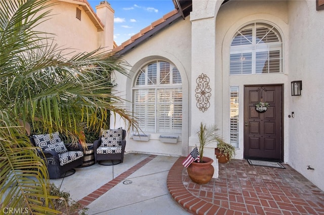 doorway to property with a patio and stucco siding