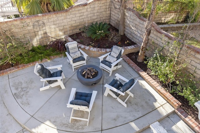 exterior space with an outdoor fire pit and fence