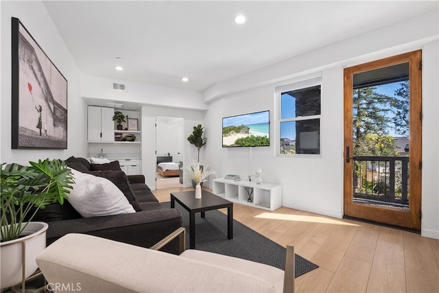 living room with light hardwood / wood-style flooring