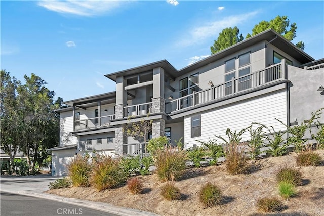 contemporary house with a balcony and a garage