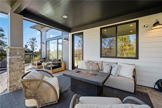 view of patio / terrace featuring an outdoor living space with a fire pit