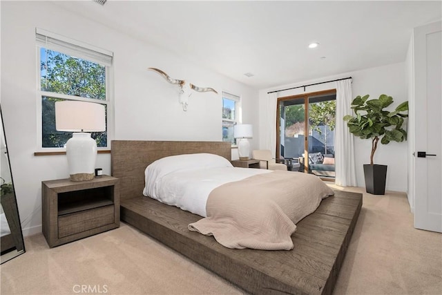 bedroom featuring light colored carpet and access to outside