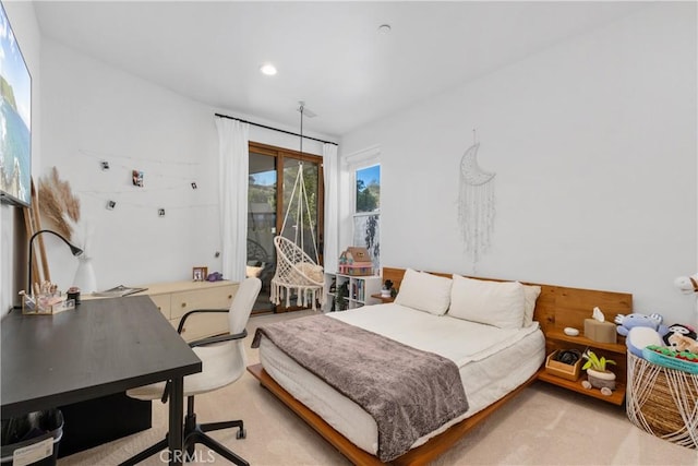 bedroom featuring light colored carpet and access to outside