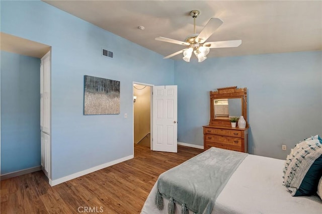 bedroom with lofted ceiling, hardwood / wood-style flooring, and ceiling fan