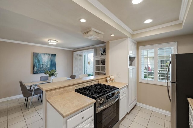 kitchen featuring white cabinets, light tile patterned flooring, kitchen peninsula, and appliances with stainless steel finishes