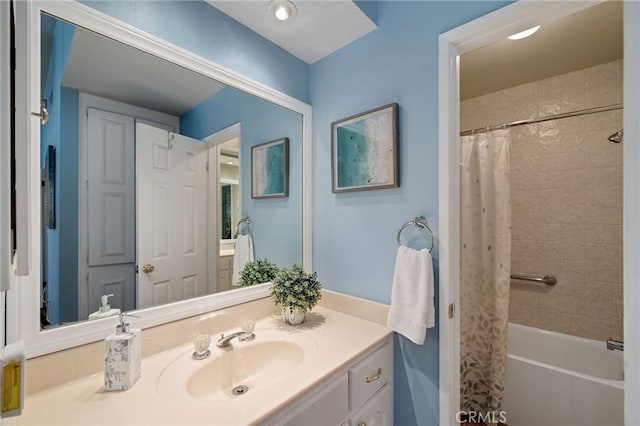 bathroom featuring shower / bathtub combination with curtain and vanity