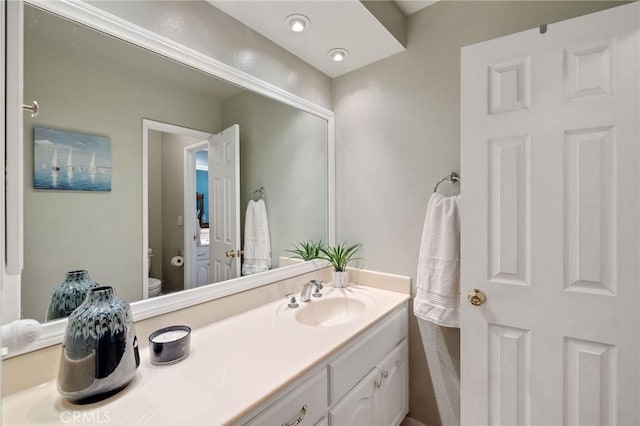 bathroom featuring toilet and vanity