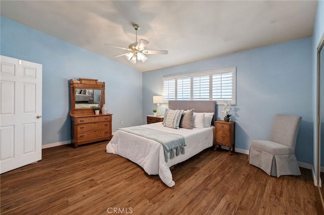 bedroom featuring dark hardwood / wood-style flooring, ceiling fan, and vaulted ceiling