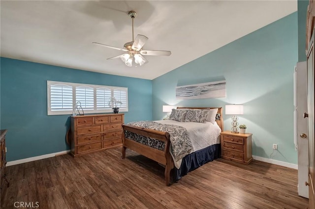 bedroom featuring ceiling fan, dark wood-type flooring, and lofted ceiling