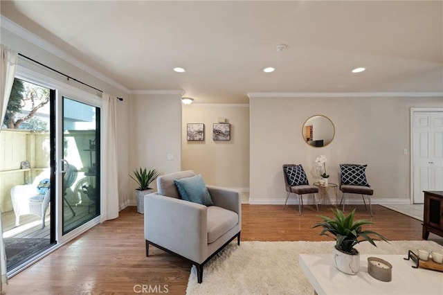 sitting room featuring ornamental molding and light hardwood / wood-style floors