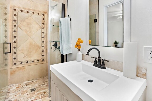 bathroom featuring vanity and an enclosed shower