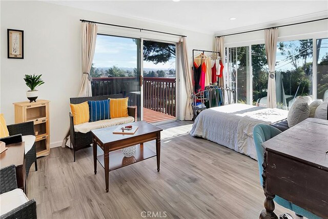 bedroom featuring light hardwood / wood-style flooring and access to outside