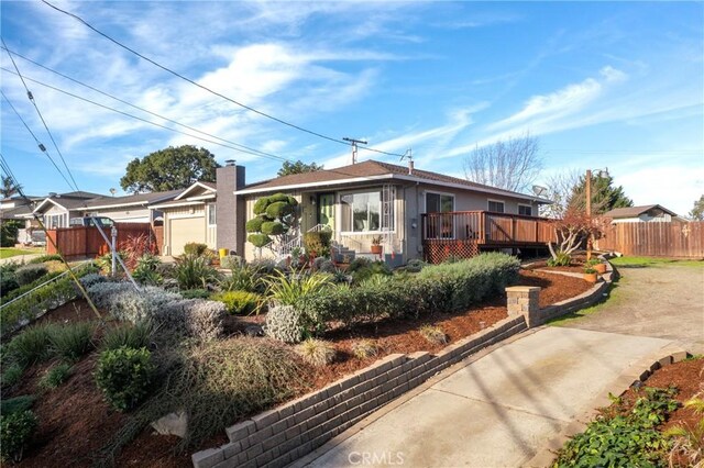 view of front of property featuring a deck and a garage