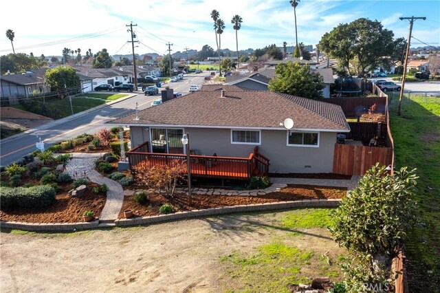 rear view of house with a lawn and a wooden deck