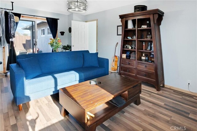 living room featuring hardwood / wood-style flooring and a chandelier