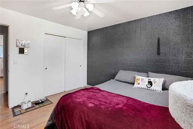 bedroom featuring a closet, ceiling fan, and hardwood / wood-style floors