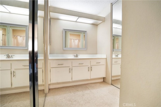 bathroom with a textured ceiling and vanity