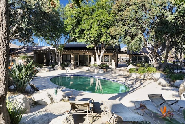 view of swimming pool with a patio