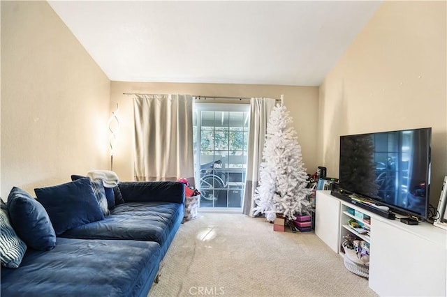 living room featuring vaulted ceiling and carpet