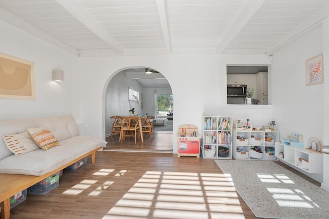 living room featuring beam ceiling, ceiling fan, wood ceiling, and hardwood / wood-style floors