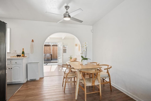 dining space featuring ceiling fan and dark hardwood / wood-style flooring