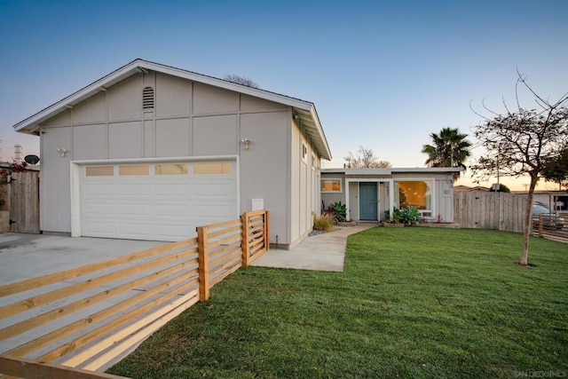 view of front of property with a yard and a garage