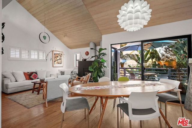 dining room with wooden ceiling, high vaulted ceiling, an inviting chandelier, and light hardwood / wood-style flooring