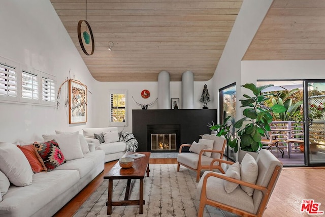 living room with lofted ceiling, wood ceiling, and light hardwood / wood-style floors