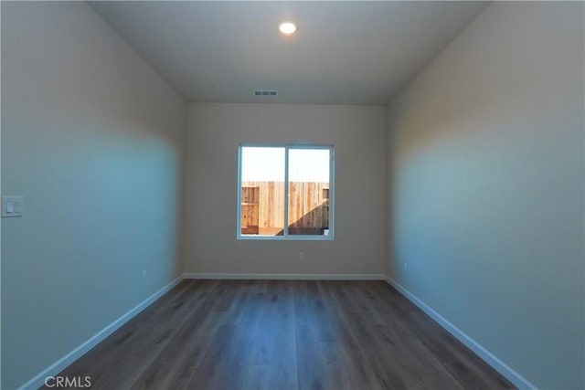 unfurnished room featuring dark hardwood / wood-style flooring