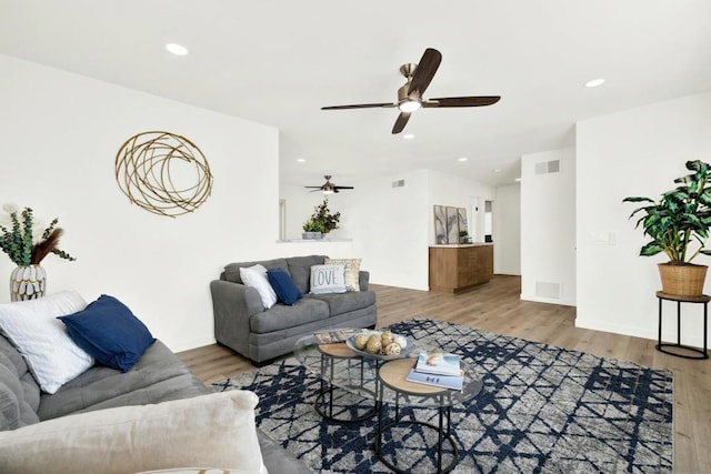 living room featuring ceiling fan and wood-type flooring