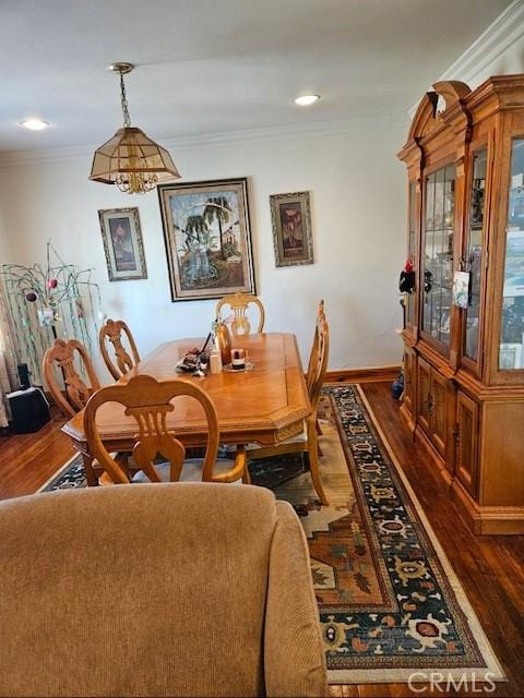 dining space featuring ornamental molding and hardwood / wood-style floors