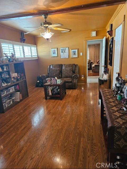 living room featuring ceiling fan and hardwood / wood-style flooring