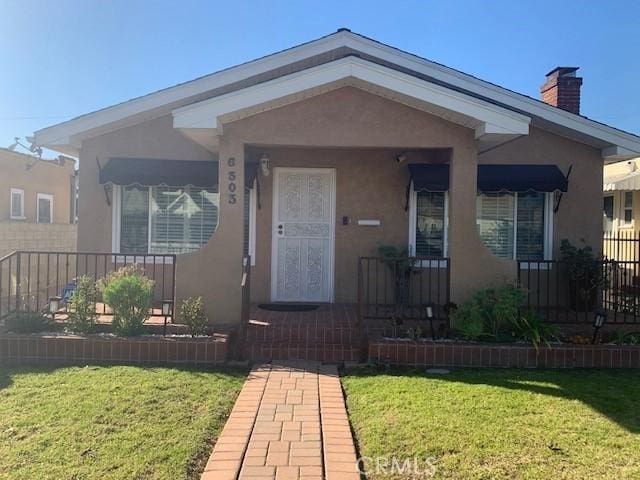 bungalow-style home with a front lawn