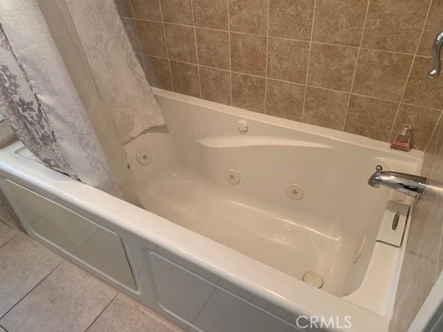 bathroom featuring tile patterned flooring and a bathtub