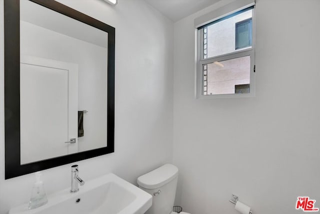 bathroom featuring sink and toilet