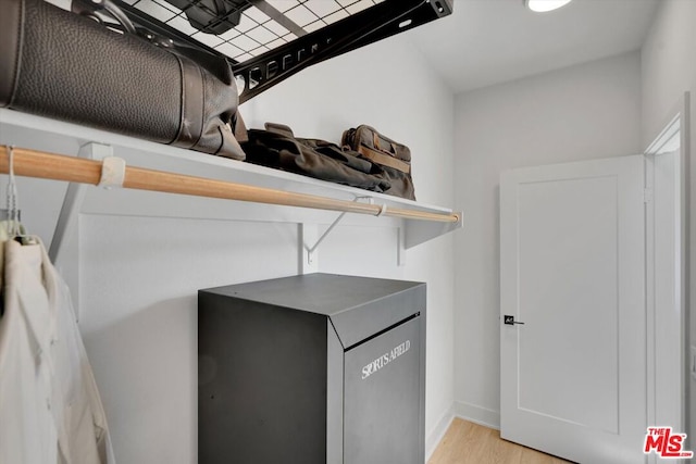 laundry area featuring light wood-type flooring